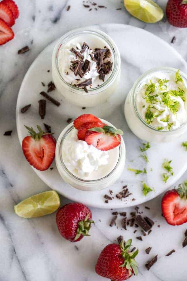 Coconut Mousse in glass jars on a white plate.