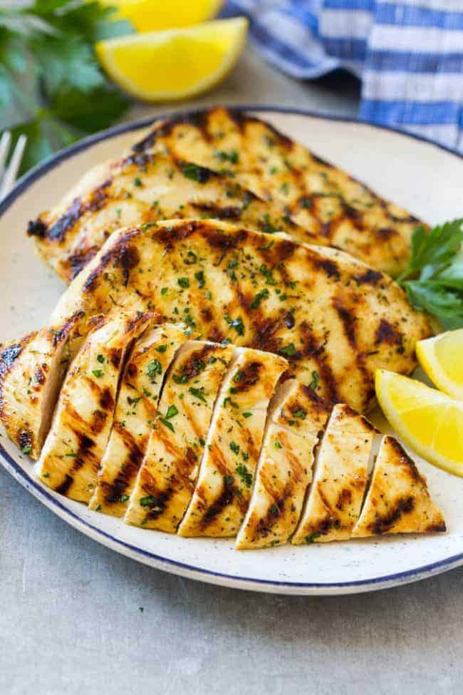 Sliced grilled citrus and herb chicken on a plate. 