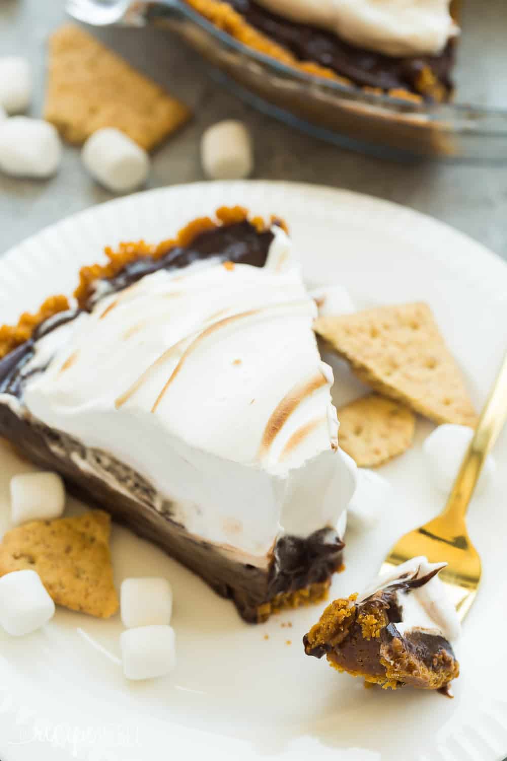 Slice of No Bake S'mores Pie on a white plate. 