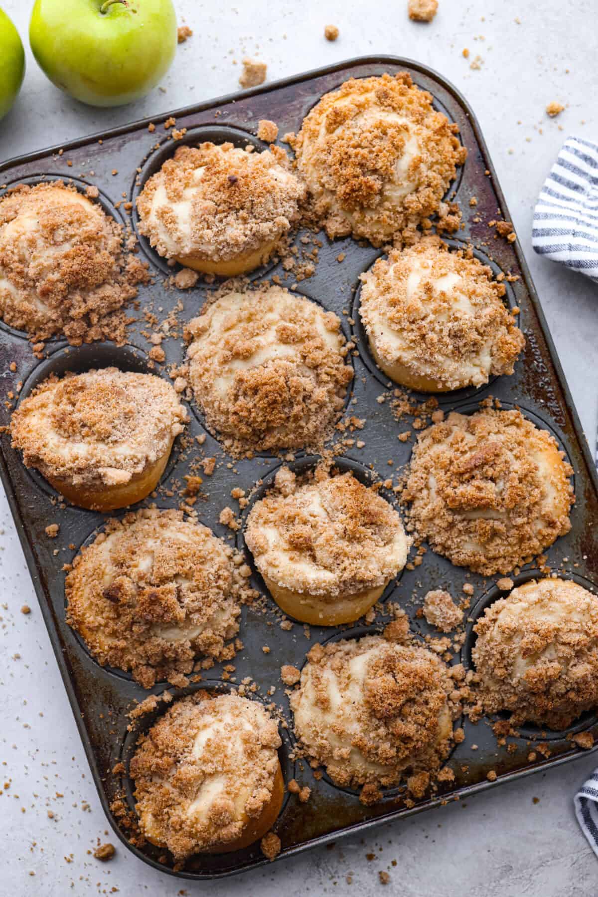 Top view of apple crumb muffins in a muffin pan.