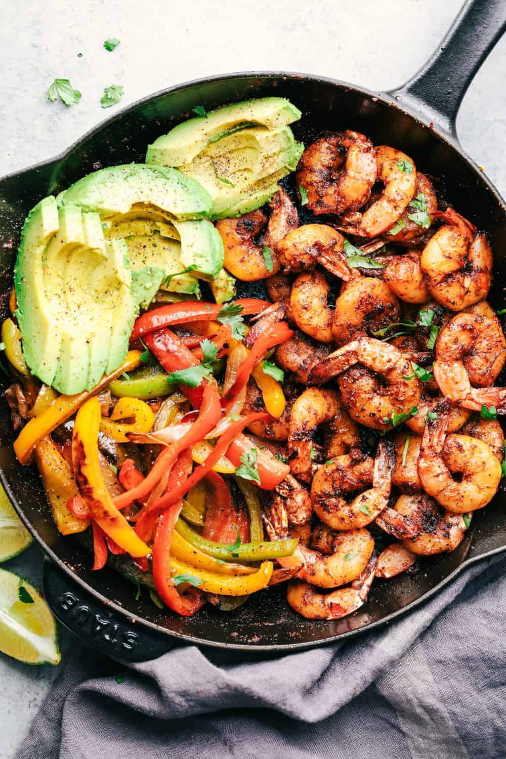 20 Minute Skillet Blackened Shrimp Fajitas in a cast iron skillet.