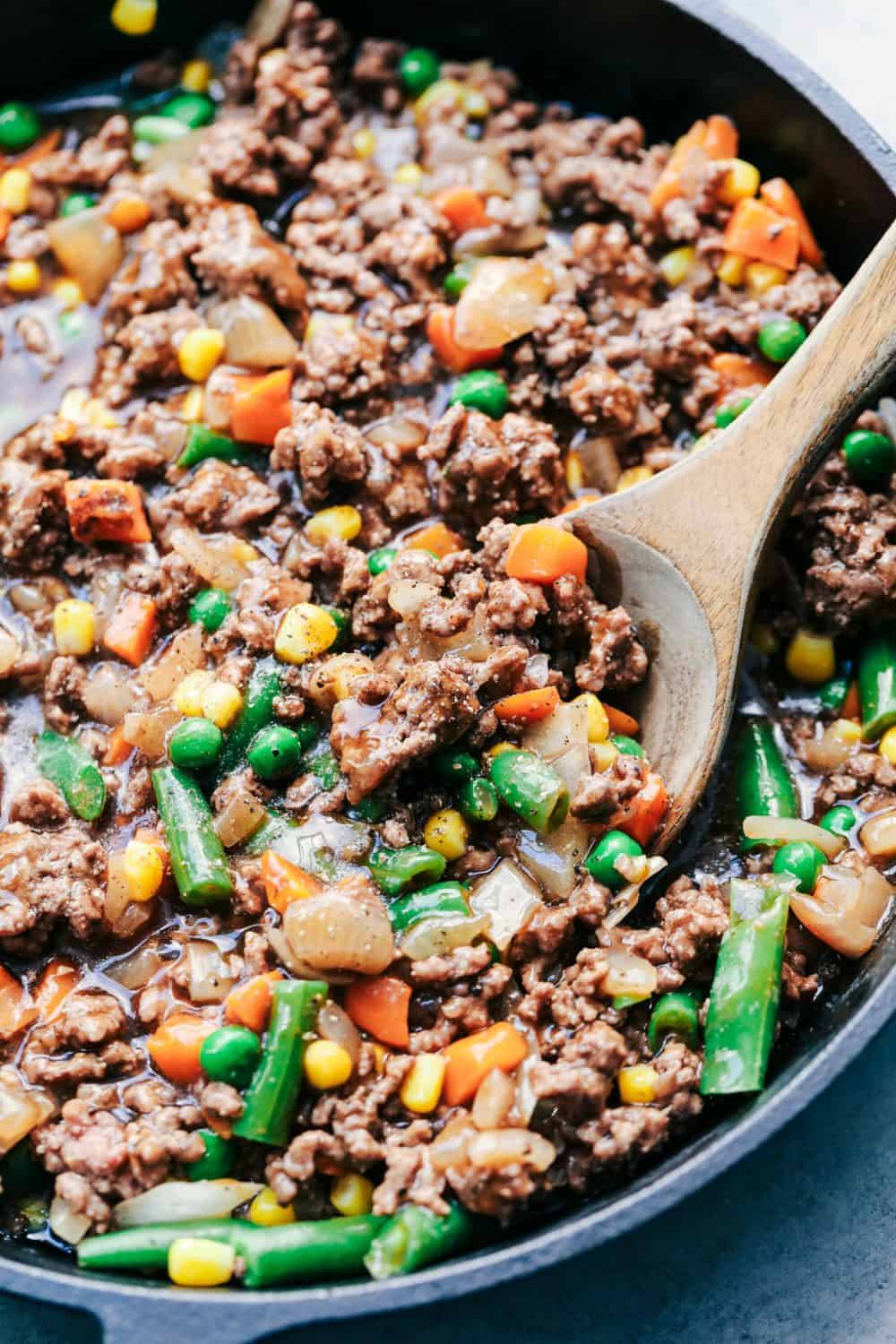 Skillet Sweet Potato Shepherds Pie with a wooden spoon.