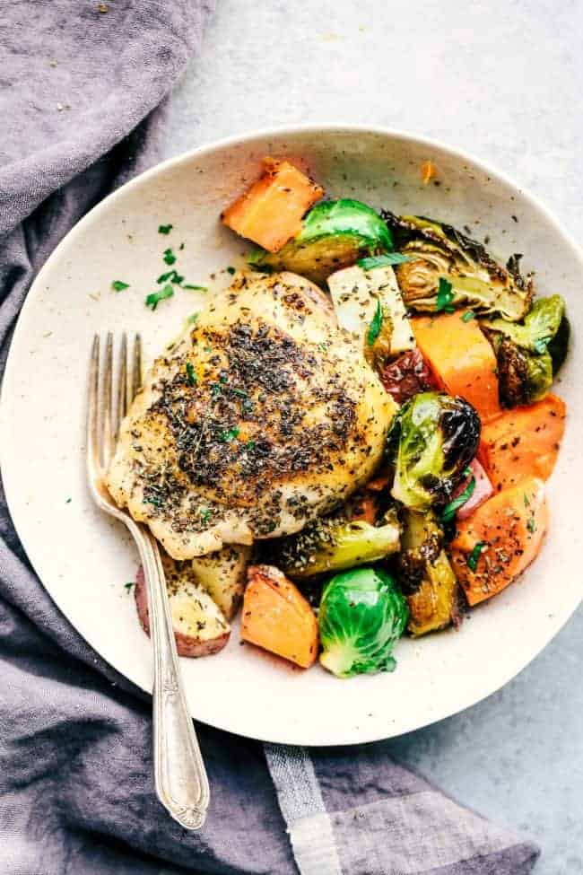 Sheet Pan Roasted Garlic Butter Herb Chicken with Potatoes and Brussels Sprouts on a plate.