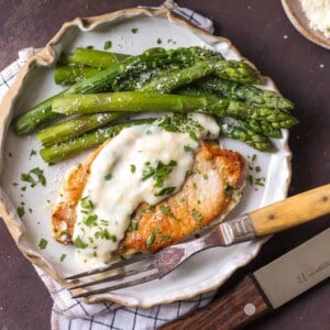 These Creamy Parmesan Pork Chops are sure to be a hit around the family table. The simple garlic parmesan sauce is oh so delicious and so easy anyone can make it in minutes. 