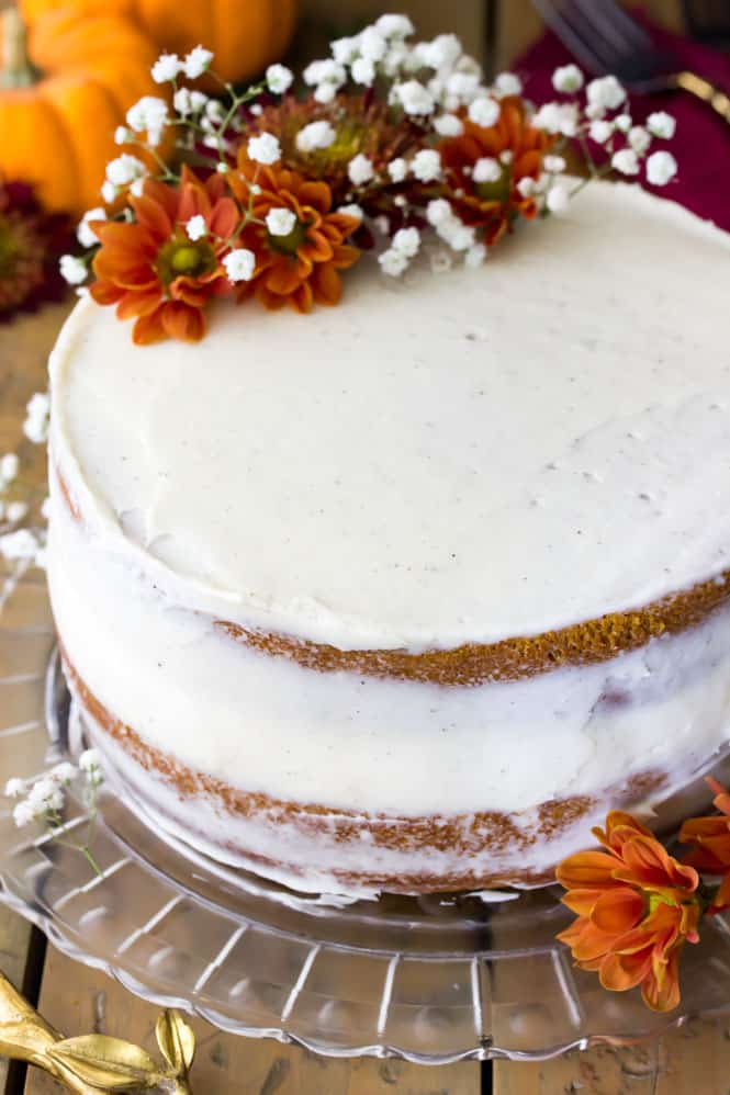 A soft, moist, and EASY Pumpkin Cake, iced and decorated with flowers.