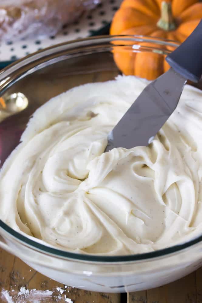 Vanilla bean frosting in a glass bowl.