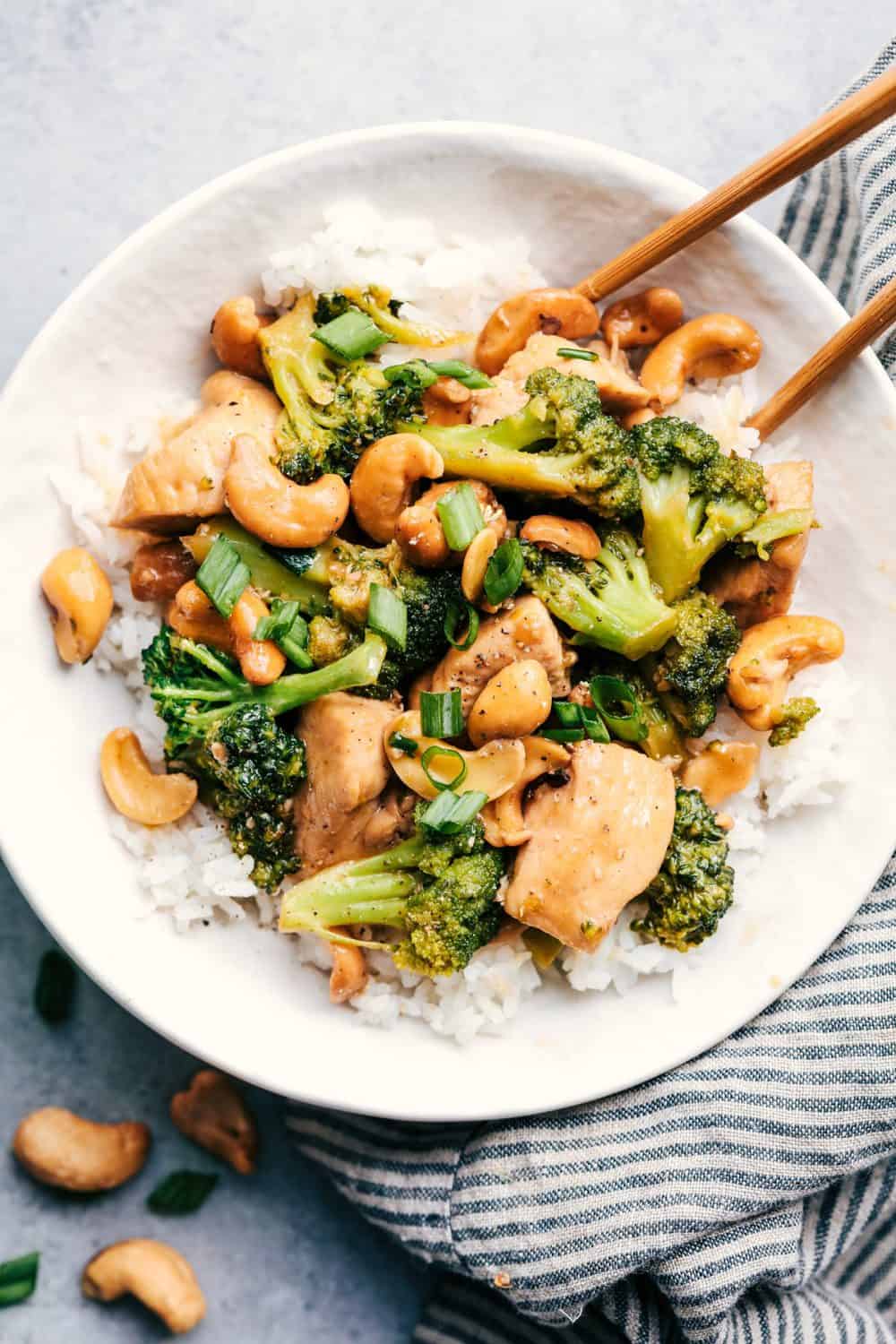 Garlic Chicken and Broccoli Cashew Stir Fry with white rice and chopsticks.