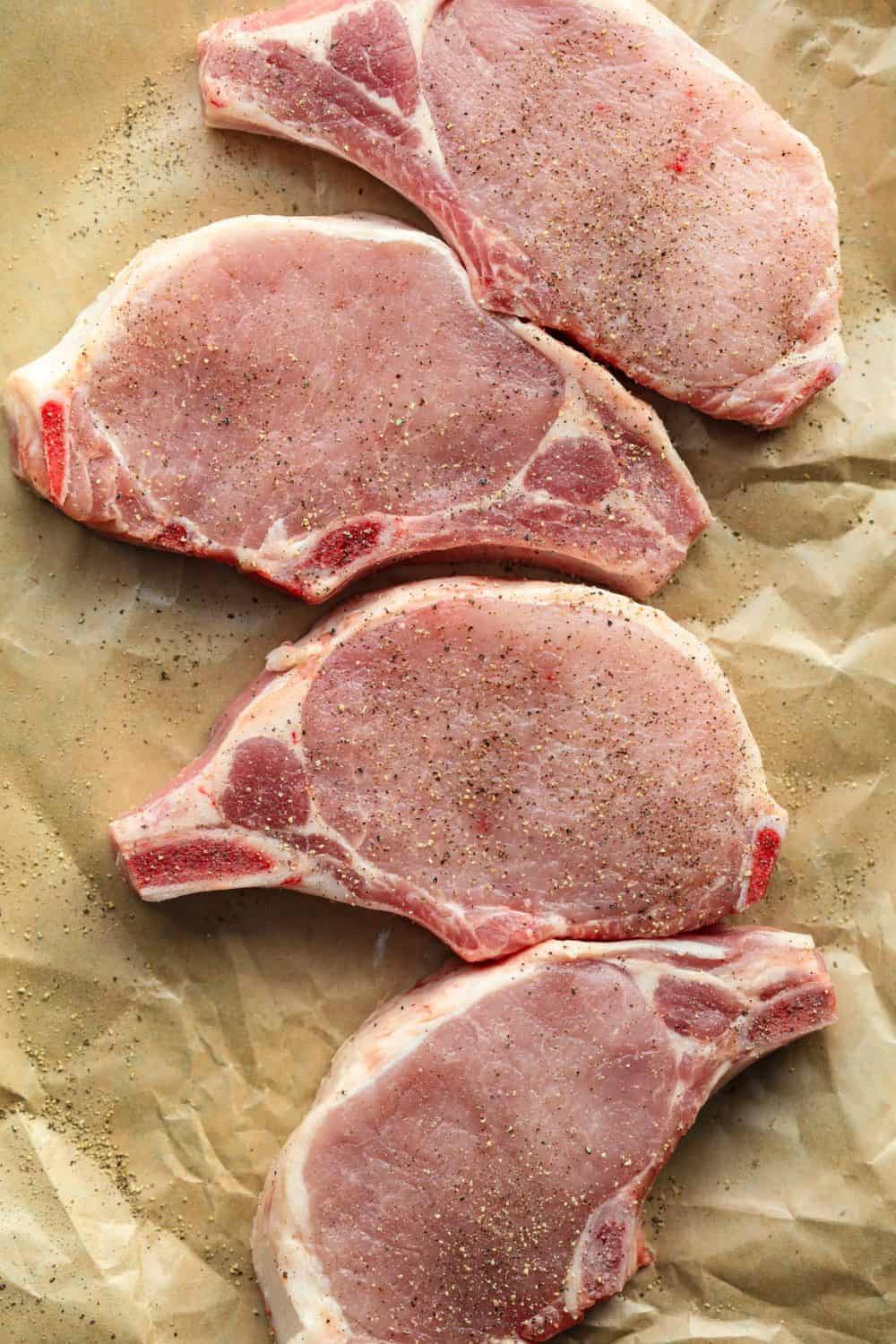 Seasoned raw pork laid out of paper.