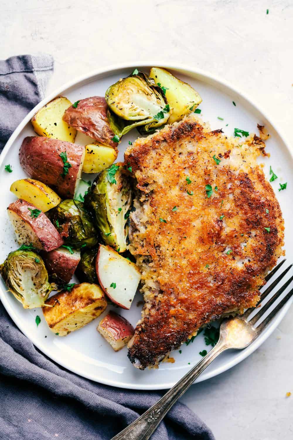 Sheet Pan Crispy Cheddar Pork Chops on a white plate. 