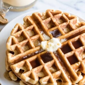 Light and fluffy waffles made with eggnog and drizzled with a homemade cinnamon syrup. 