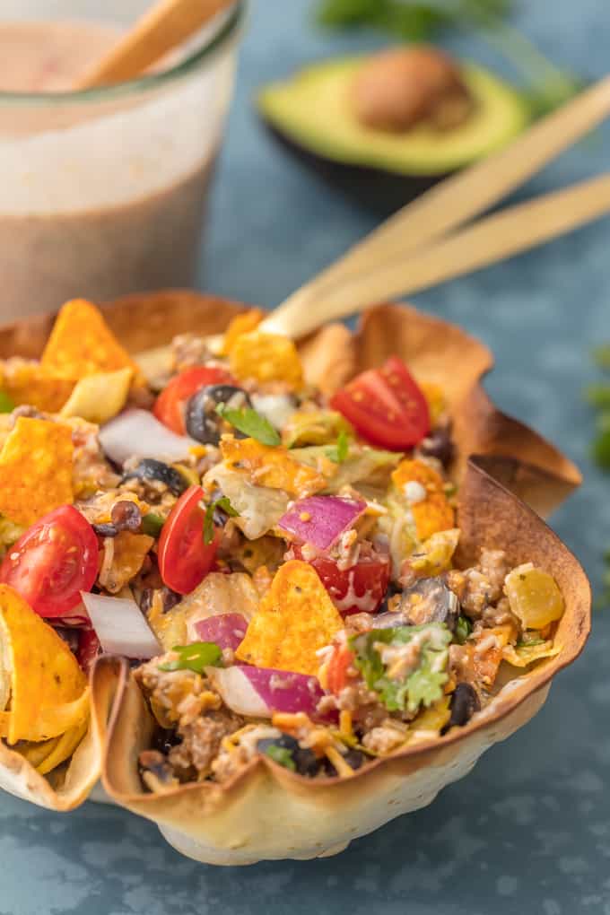 Creamy Taco Salad with bean dip in the background. 