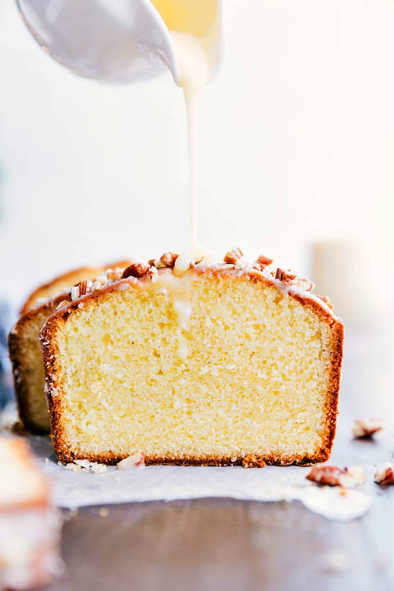 Glazed Eggnog Pound Cake getting drizzled with a luscious glaze.