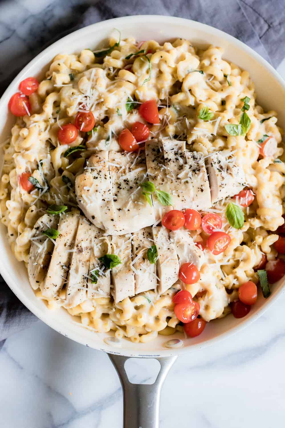 Chicken Caprese Mac and Cheese. A quick and easy one pot meal loaded with juicy chicken, cheesy pasta and fresh tomatoes and basil.