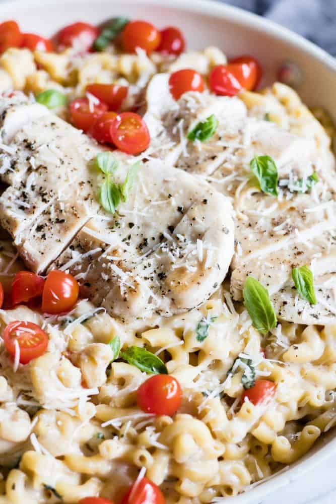 Chicken Caprese Mac and Cheese in a white bowl. 