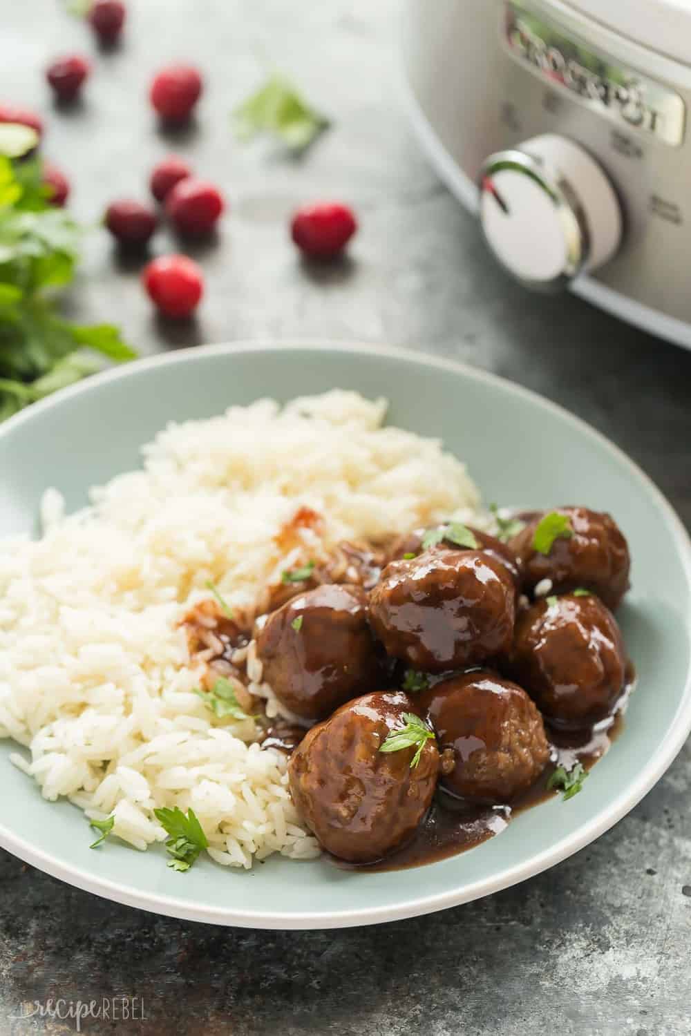 Slow Cooker Cranberry Balsamic Meatballs with white rice on a plate.