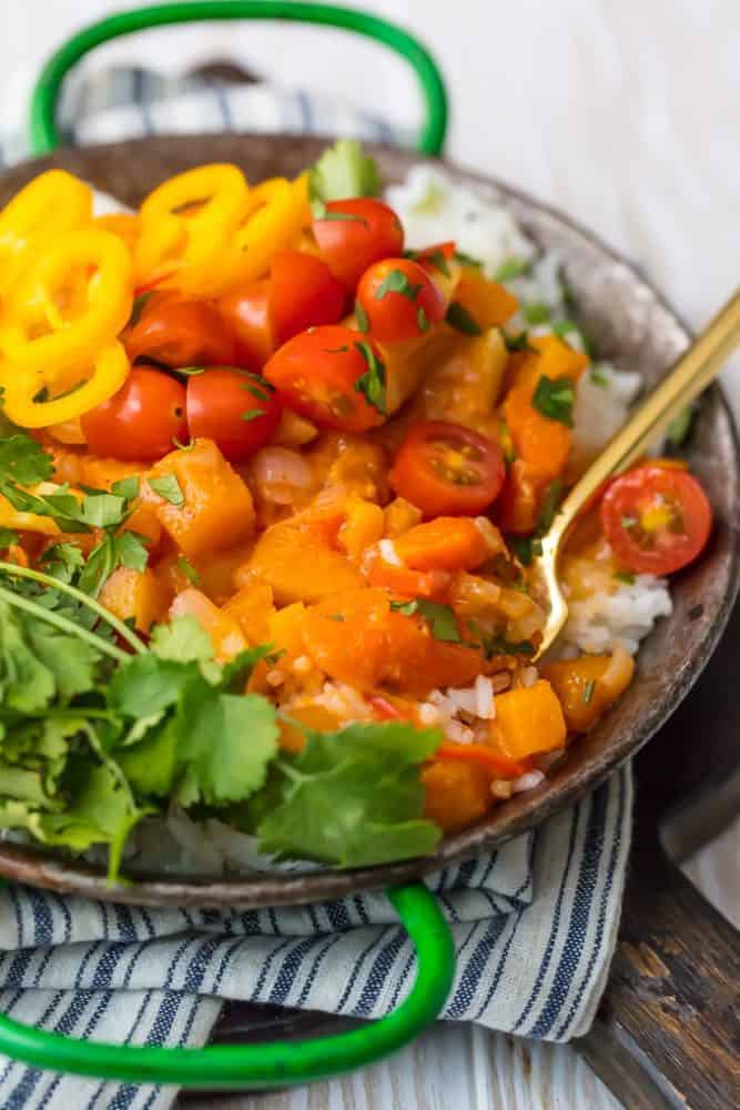 Vegetable Curry over white rice with fork in a bowl. 