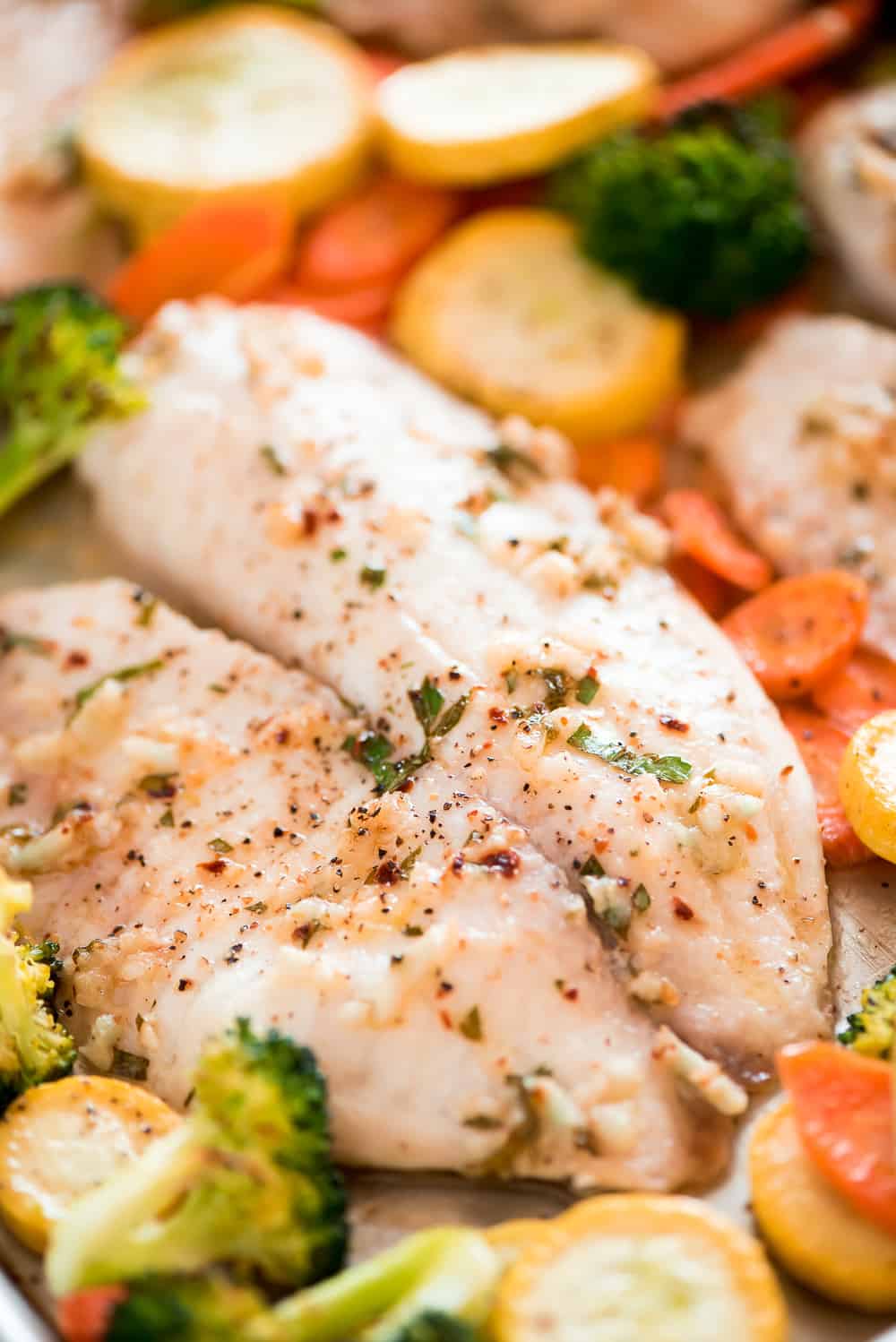 This Baked Tilapia and Roasted Veggies is a low calorie and high protein dish that comes together in less than 25 minutes! 