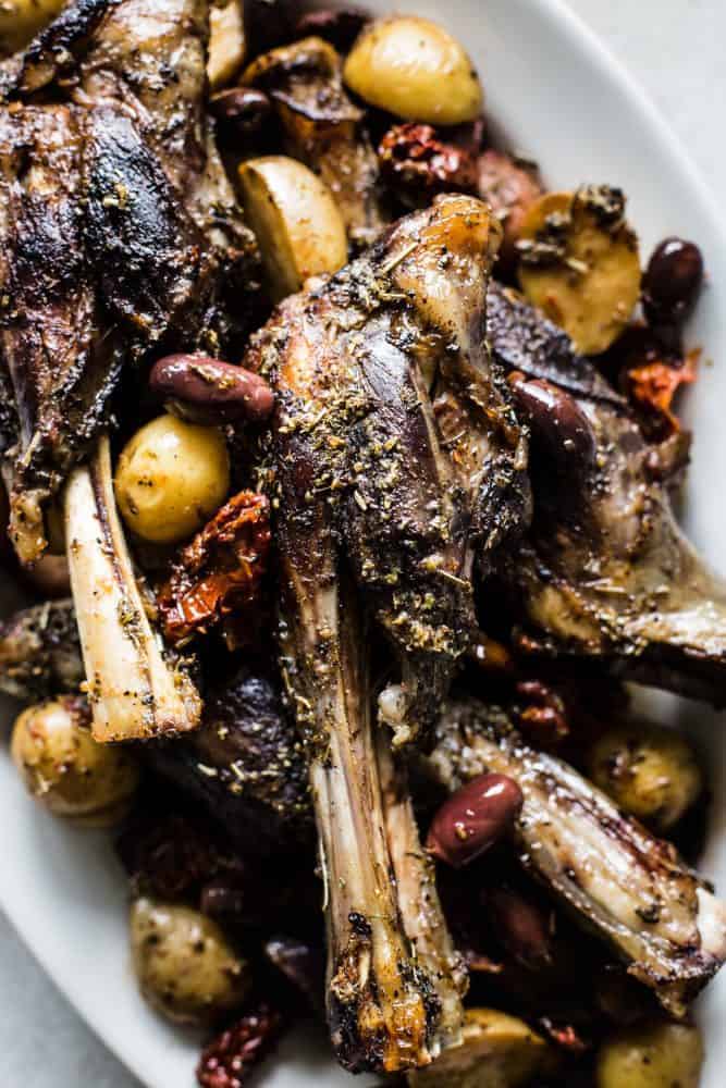 Close-up of Slow Cooker Greek Lamb Shanks on a white plate. 