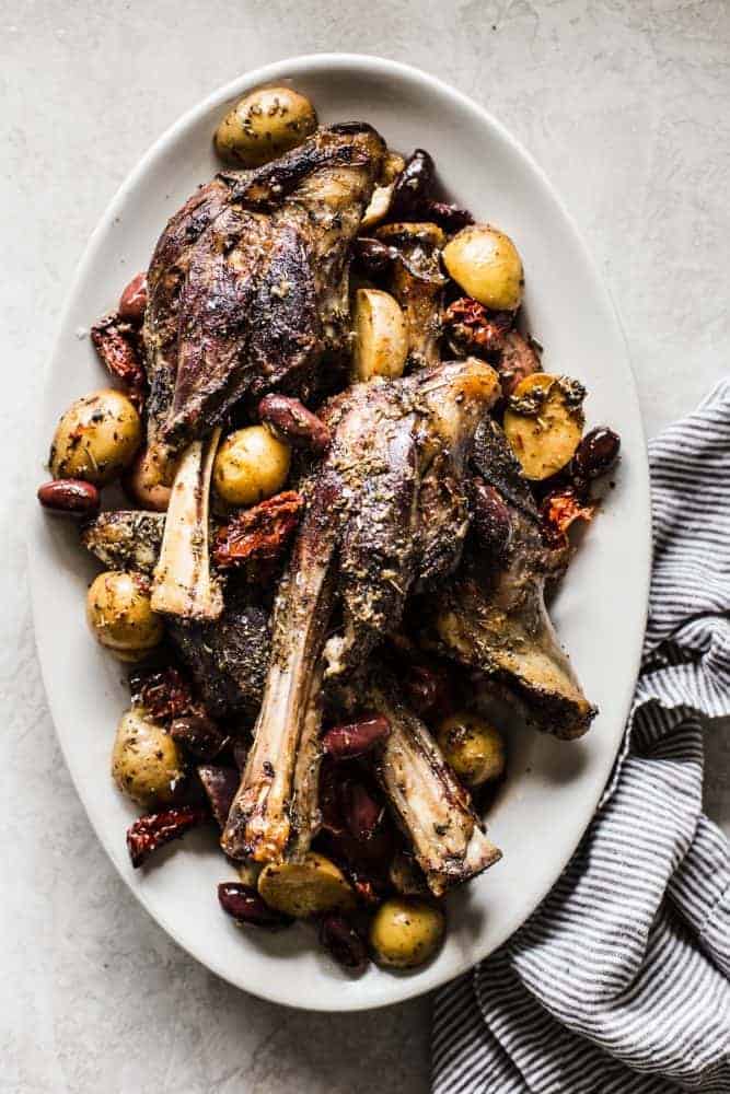 Slow Cooker Greek Lamb Shanks on a white platter.