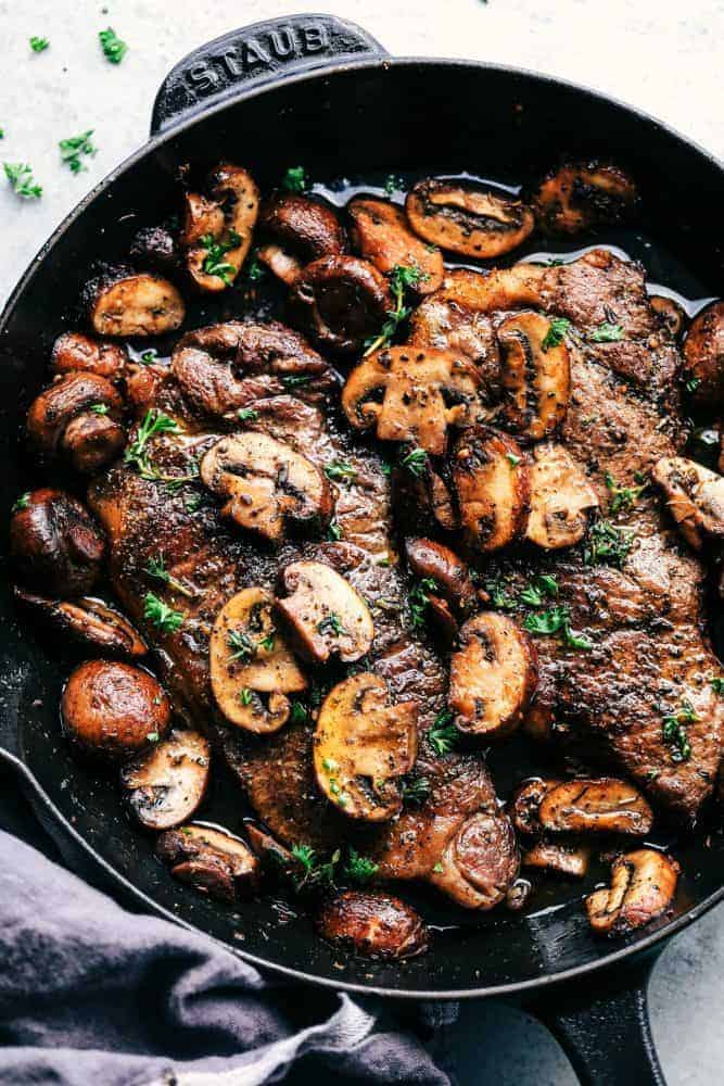 Garlic Butter Herb Steak and Mushroom in a skillet. 