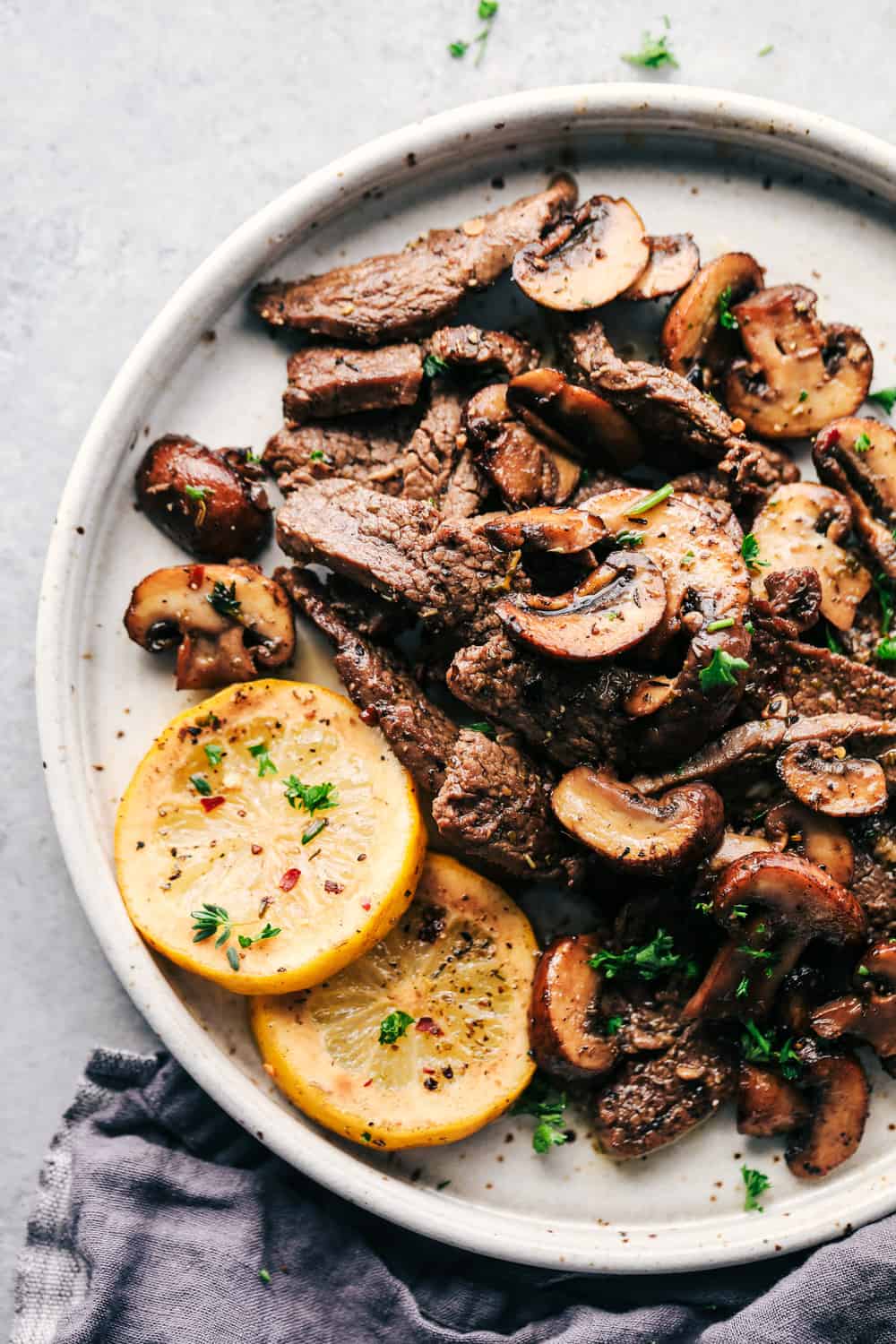 Lemon Garlic butter flank steak with mushrooms on a plate