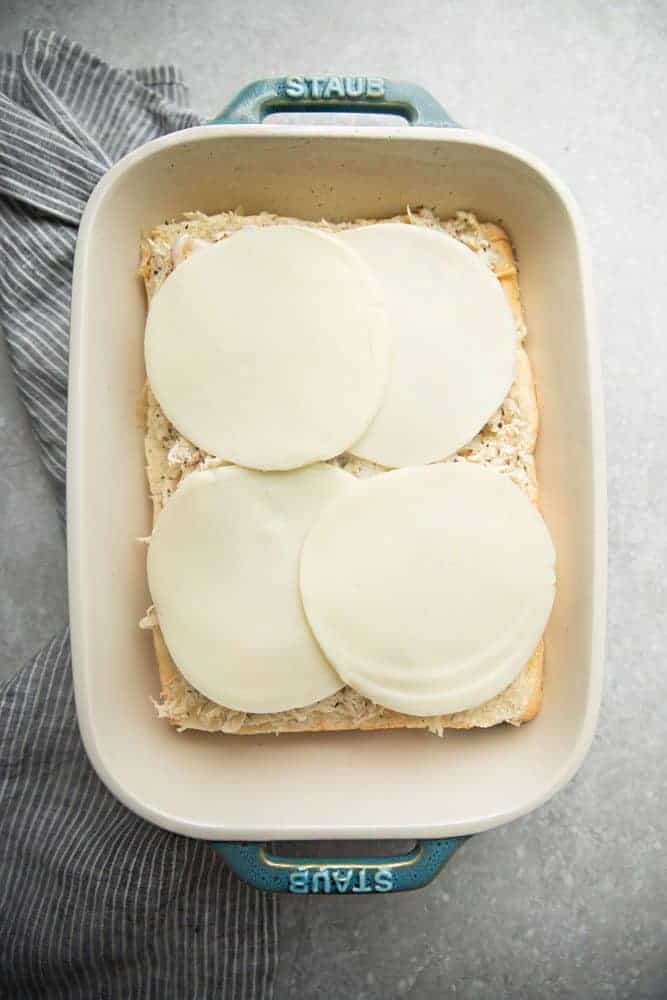 Cheese on break in a white iron pan. 