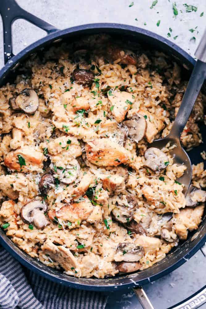 Creamy Parmesan Chicken with Mushroom Rice in a skillet.