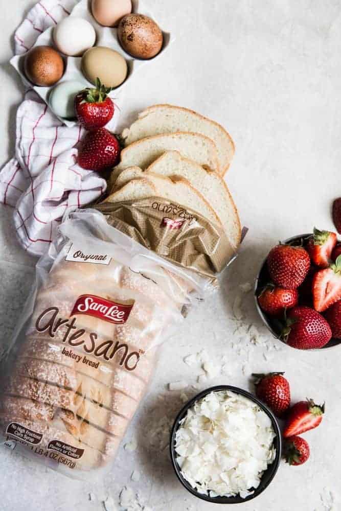 Loaf of SarahLee Bread with un-cracked eggs and fresh cut strawberries. 