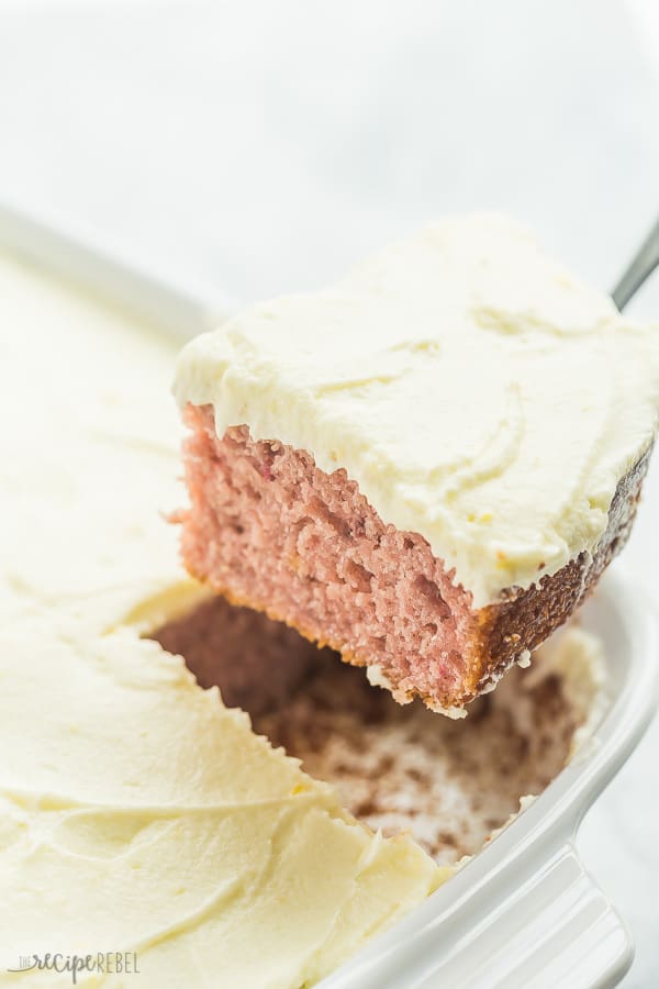 Once piece of strawberry cake in a white pan. 