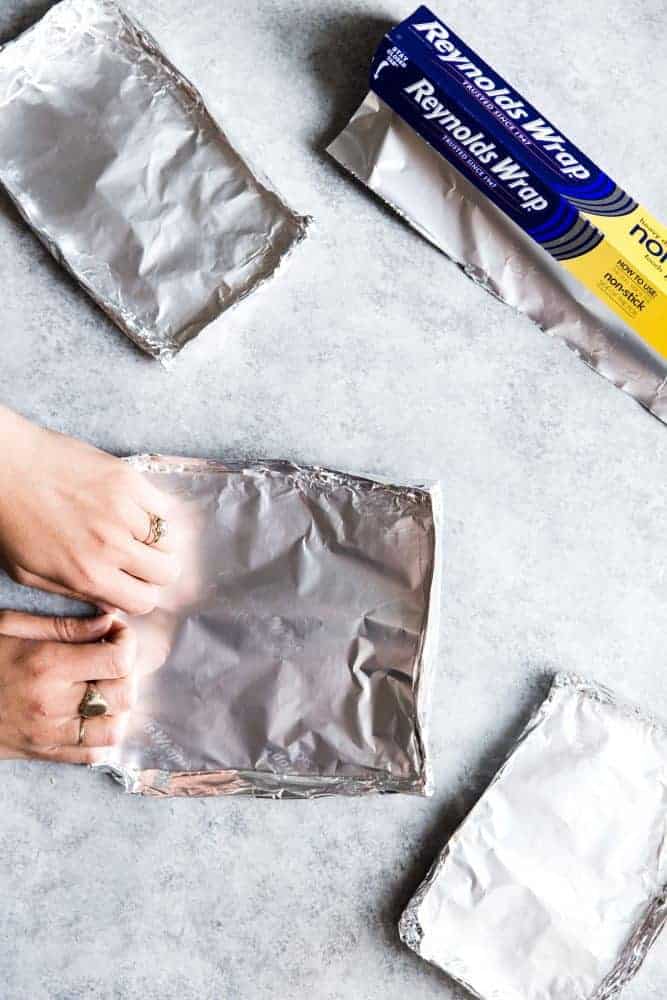 Reynolds Wrap Aluminum Foil being used to make small trays for the nachos. 