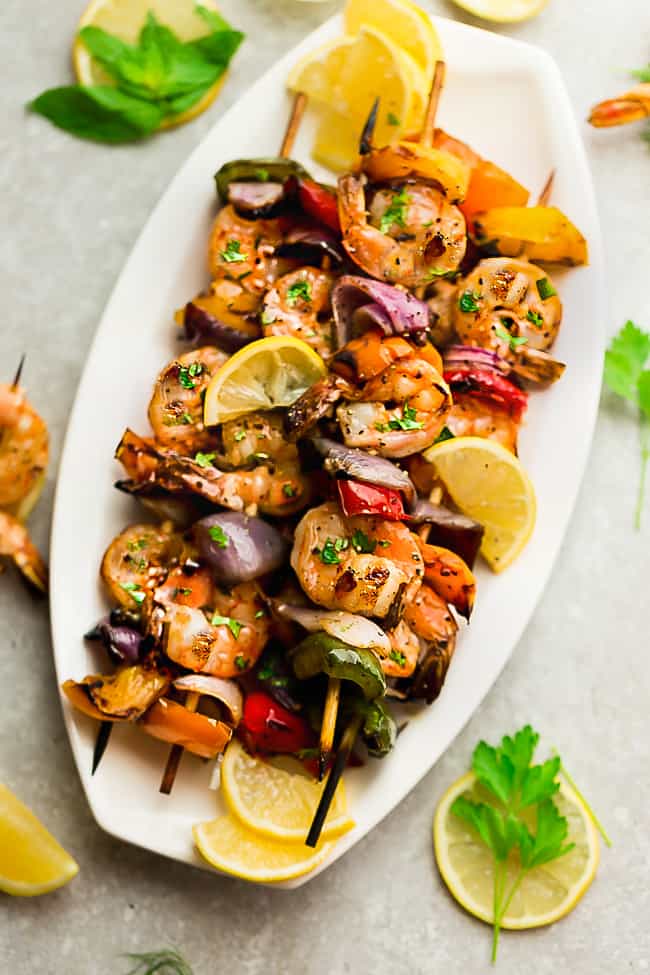 Grilled Lemon Garlic Butter Shrimp with Vegetables on a white platter. 