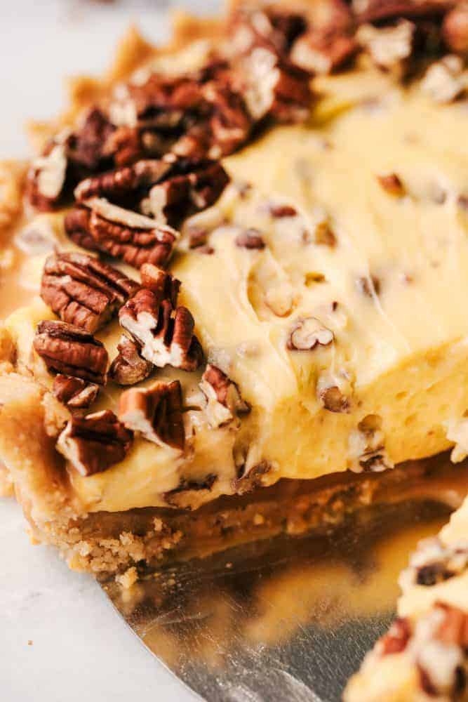 No Bake Banana Caramel Pecan Pie with a slice removed. 