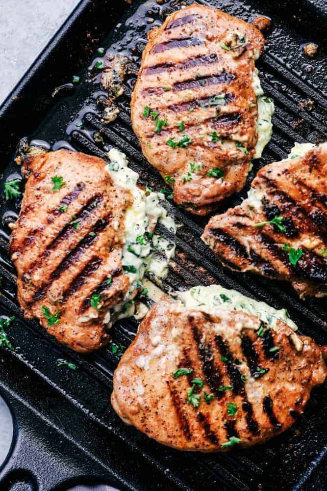 Cooked Herb Stuffed Pork Chops on a grill pan. 