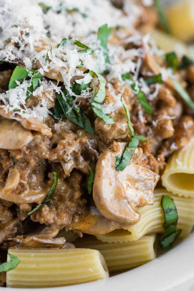 Close up of Creamy Sausage Mushroom Rigatoni in a white bowl. 