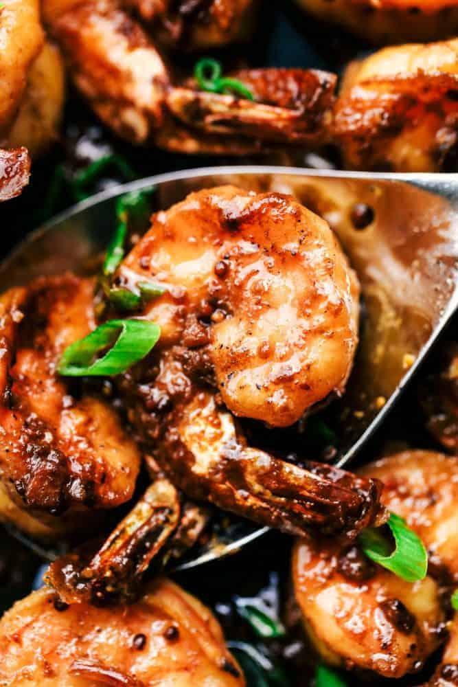 Close-up of a spoonful of Cajun Garlic Butter Shrimp. 