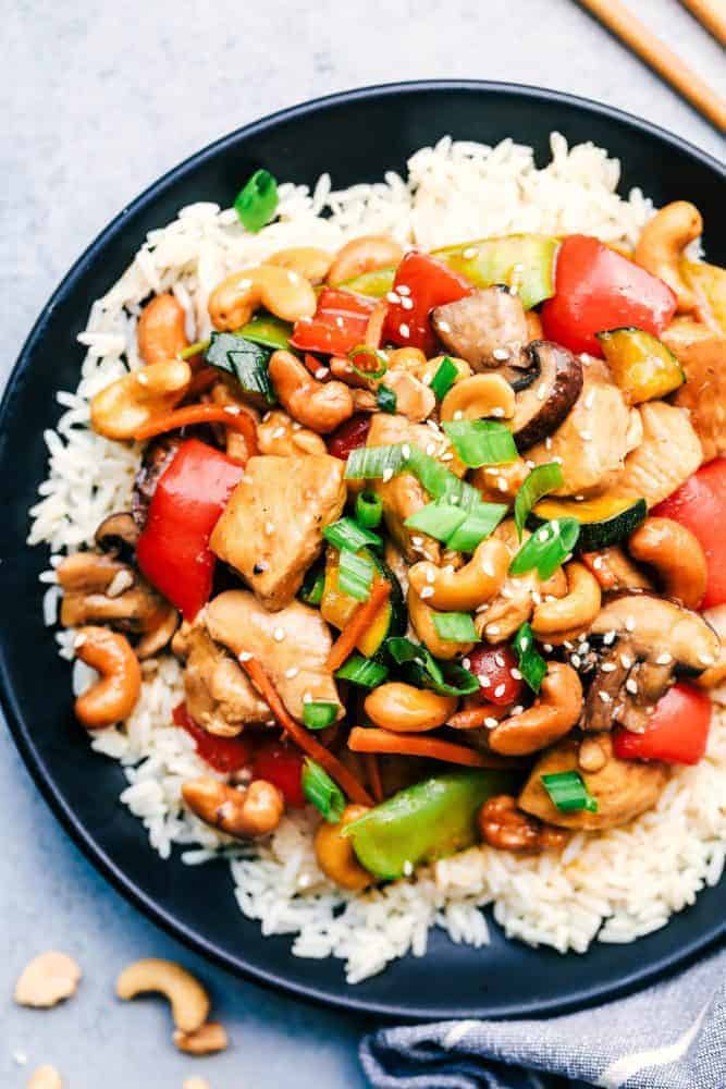 Cashew Chicken Stir Fry over white rice in a black bowl. 