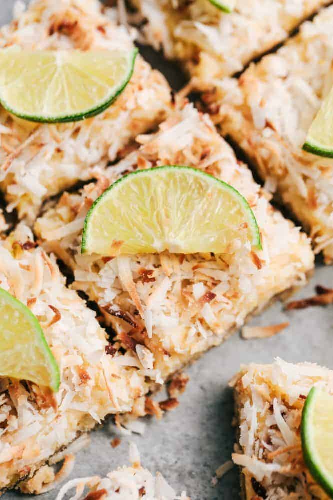 Close up of sliced Coconut Lime Butter Bars with freshly sliced lime on top. 