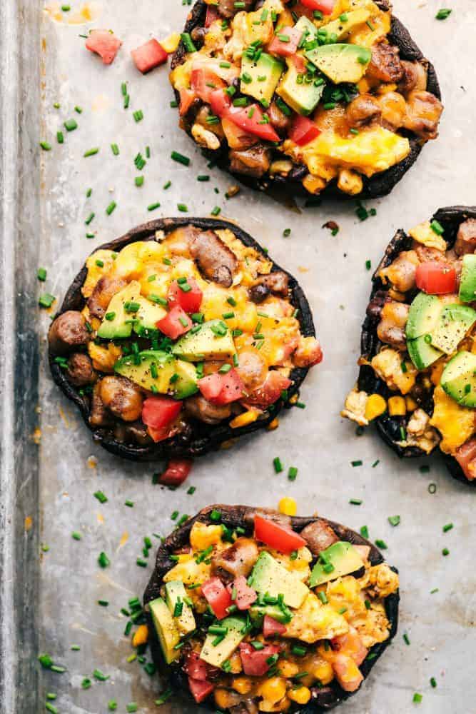 Southwest Sausage and Egg Stuffed Portobello Mushrooms on a cooking sheet. 