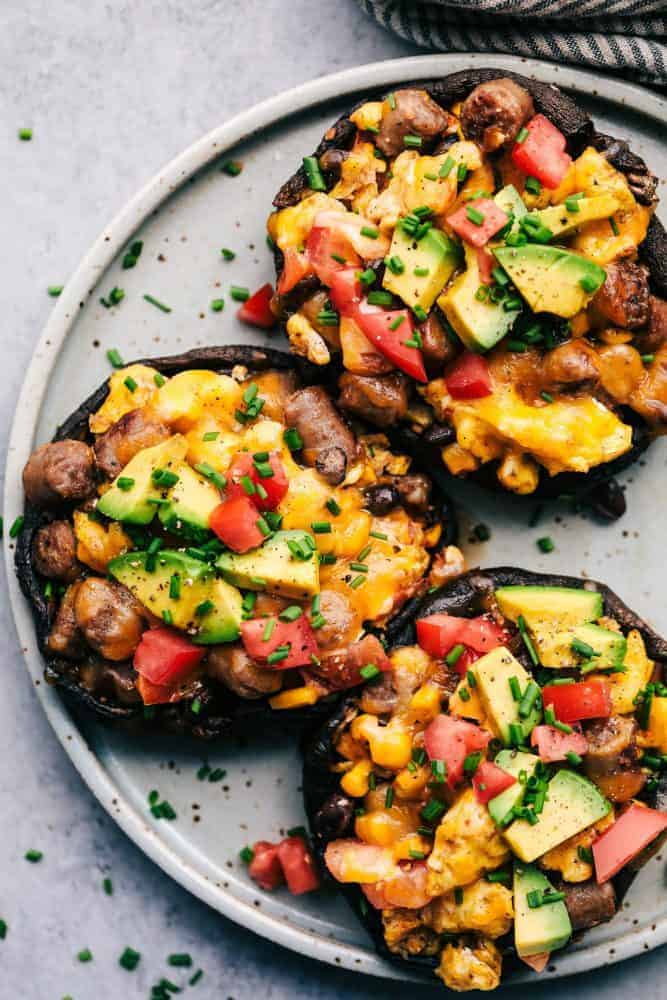 Southwest Sausage and Egg Stuffed Portobello Mushrooms on a white plate. 