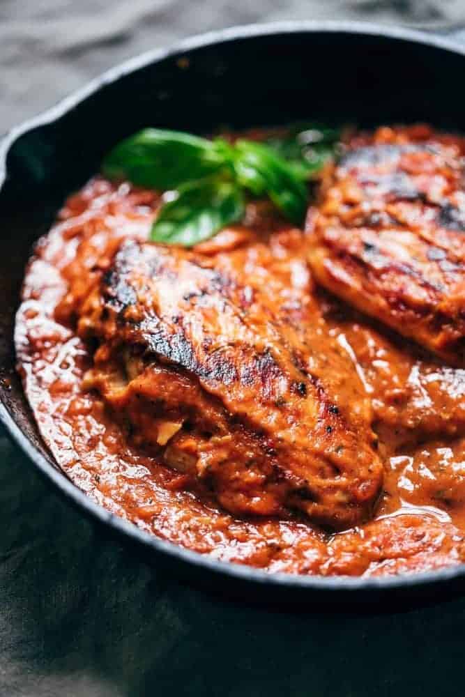 Creamy tomato basil chicken in a cast iron skillet ready to be served.