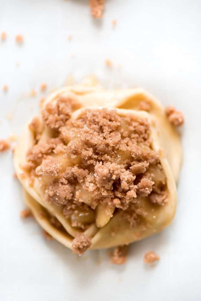 Un-cooked Apple Danish with crumbs on top. 