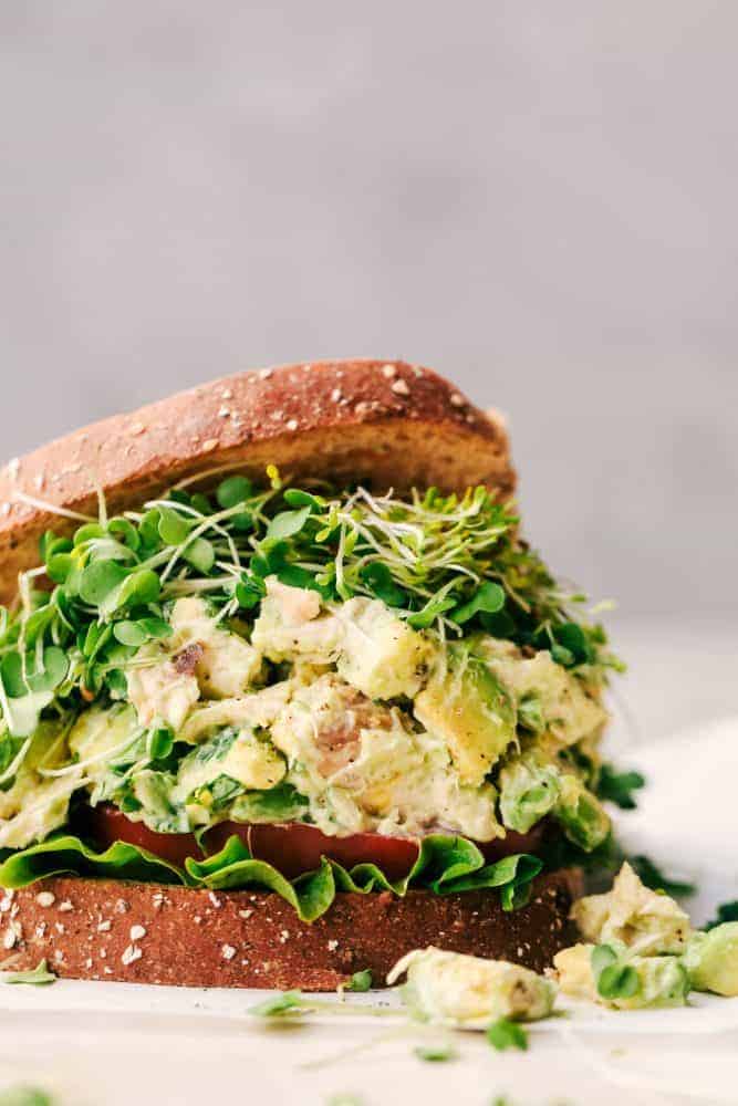 Avocado Chicken Salad between two slices of bread. 