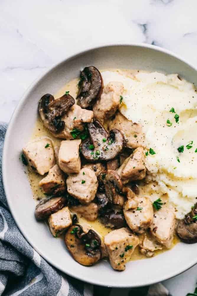 Plate of Creamy Garlic Pork Marsala with mashed potatoes. 