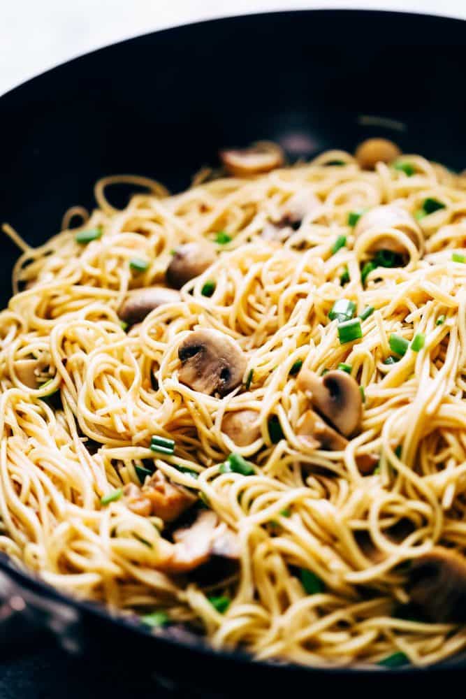 Closeup of garlic mushroom noodles in a wok.