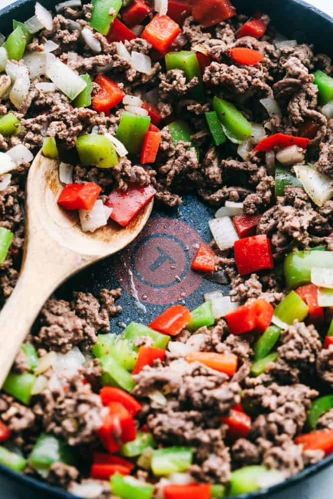 Unstuffed Pepper Skillet in a skillet with a wooden spoon. 