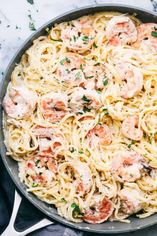 Creamy garlic shrimp Alfredo pasta and a skillet.