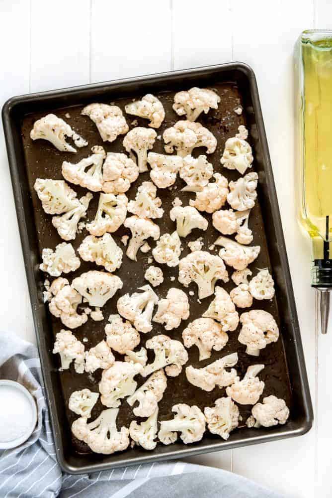 Parmesan roasted cauliflower on a baking sheet with olive oil I have on the side. 