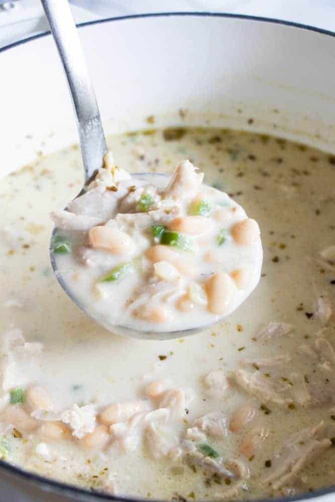 A ladle full of Creamy White Chicken Chili. 