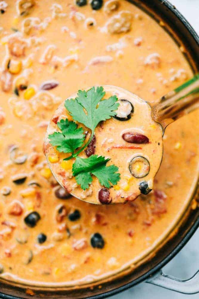 Large bowl and ladle with Cheesy Taco Soup. 