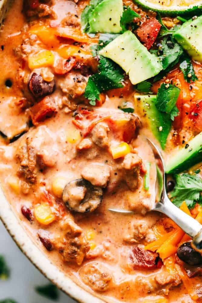 Cheesy Taco Soup in a bowl with a metal spoon. 